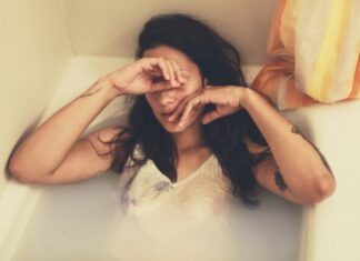 Dealing with Emotional Baggage with BestDates: How to Heal and Move Forward in Relationships A woman in the bathtub with clothes on in Daytona Beach