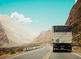 Who Is Liable in a Commercial Truck Accident: Driver, Company, or Manufacturer? white and black truck near mountain at daytime