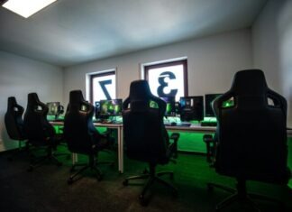 black office rolling chair near black flat screen computer monitor