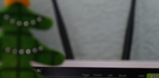 white and black modem router with four lights