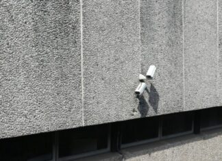 How Security Cameras Can Improve Business Safety and Security bullet security camera on concrete wall