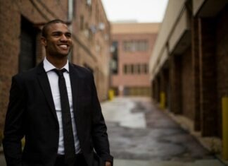 The Best Sectors to Invest in Across Africa’s Emerging Markets In 2024 smiling man standing between brown concrete buildings at daytime