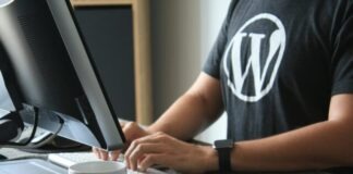 person in black and white t-shirt using computer