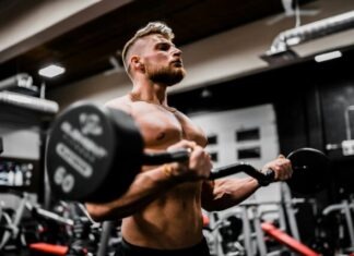 Top Reasons to Use Alphabol CR 30x 25mg for Bodybuilding Success topless man in black shorts carrying black dumbbell