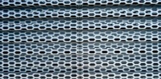 a close up of a metal structure with holes
