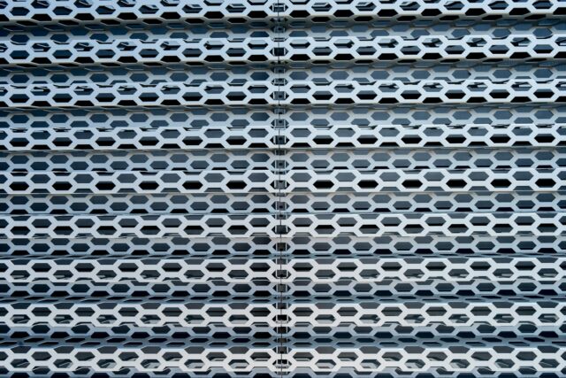 Photo by Scott Webb a close up of a metal structure with holes