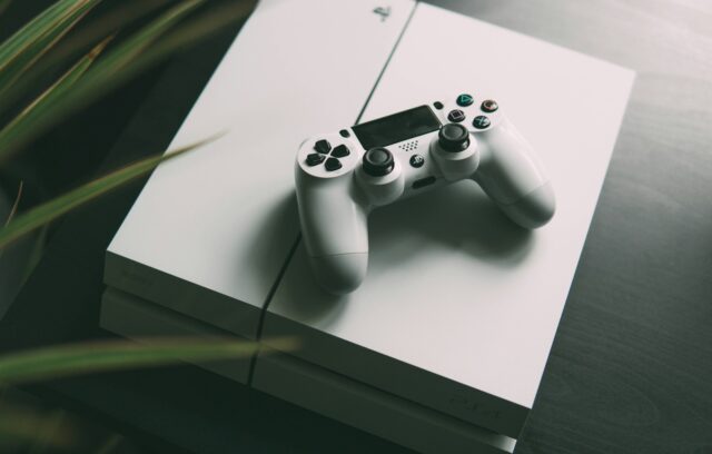 Photo by Nikita Kachanovsky selective focus photography of white Sony PS4 console with wireless controller