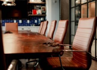 What Employers and Employees Should Know About Benefit-Related Taxes A conference room with a large wooden table and leather chairs