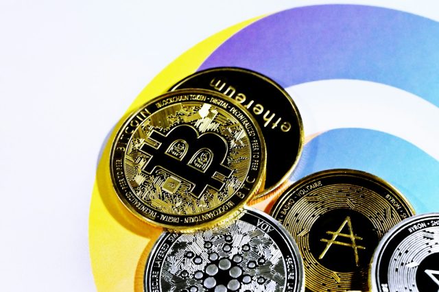 Photo by Traxer a pile of bitcoins sitting on top of each other