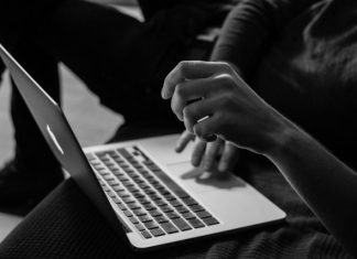 Rent a Virtual Number for Internet Registration: The Ultimate Guide grayscale photo of person using MacBook