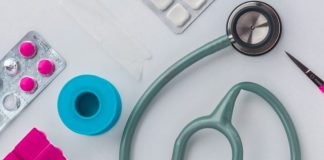 green and silver stethoscope on white envelope