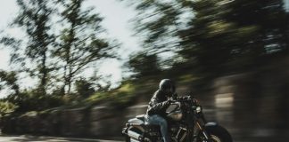 person riding cruiser motorcycle during daytime