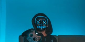 person sitting on chair while holding Xbox One controller