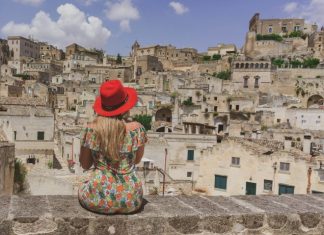 Welcome to Puglia: Beauty and Well-being in Southern Italy woman in red hat standing on gray concrete pavement during daytime