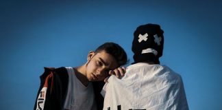 man in white and black jacket beside man in white and black crew neck shirt under
