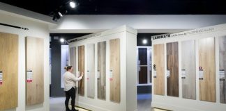 a man standing in front of a display of wooden doors