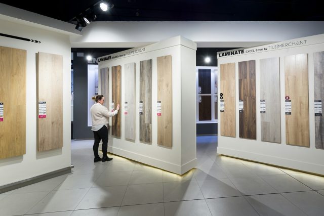 Photo by Tile Merchant Ireland a man standing in front of a display of wooden doors