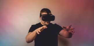 a man in a black shirt is using a virtual device