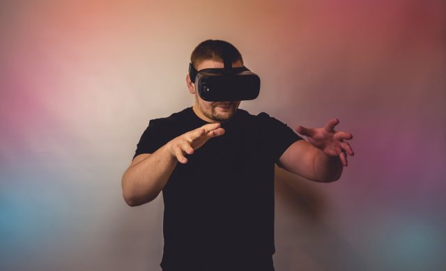 Photo by Bermix Studio a man in a black shirt is using a virtual device