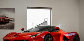 red ferrari 458 italia parked in front of white wall