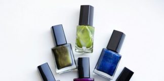 a group of five different colored nail polishes