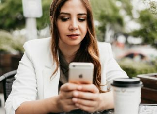 Step-by-Step to Use Temp Numbers to Test Apps Without Sharing Your Real Number woman in white blazer holding white samsung android smartphone