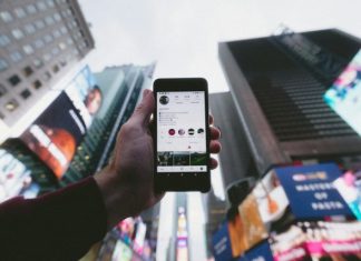 The Ever-Evolving Landscape of Technology: A Look at Current Trends and Future Implications high angle photo of person holding turned on smartphone with tall buildings background