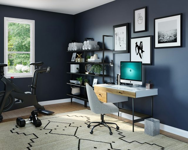 Photo by Spacejoy black flat screen computer monitor on brown wooden desk