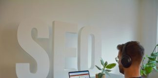 a person wearing headphones and using a laptop