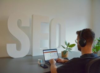 The Benefits of Enterprise SEO Software for Larger Companies a person wearing headphones and using a laptop