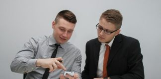 two man watching smartphone