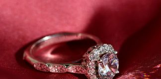 silver diamond ring on red textile