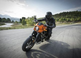 What to Know About No-Fault Insurance and Motorcycle Accident Claims person driving orange motorcycle