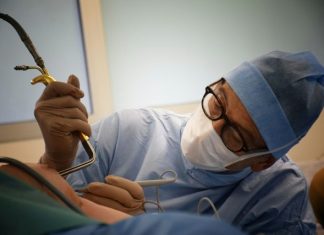 Common Misconceptions About Cosmetic Chest Procedures (and the Real Facts) person in blue hijab holding black smartphone
