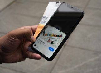 10 Must-Know Tips for Building a High-Performing eCommerce Mobile App a person holding an iphone with a credit card in their hand