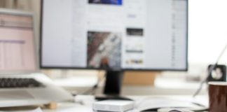 black flat screen computer monitor and gray wireless mouse