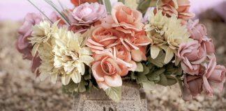 pink and white flowers on gray concrete tomb