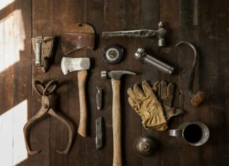 Restoring Heirloom Tools? Don’t Skip This Step clothes iron, hammer, axe, flashlight and pitcher on brown wooden table