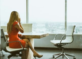 3 Reasons to Ensure That Your Workers Are Seated On Ergonomic Chairs during the Work Day woman talking through mobile phone while sitting on swivel armchair