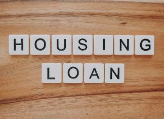 Online vs. In-Person: Which Gets You a Home Loan Faster? housing loan blocks on brown wooden surface