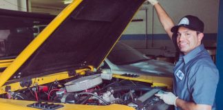 man holding open-wide car trunk