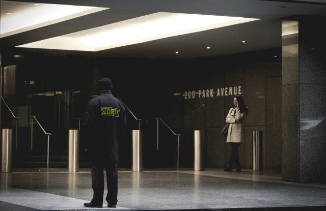 Photo by Collin security guard standing on the gray floor