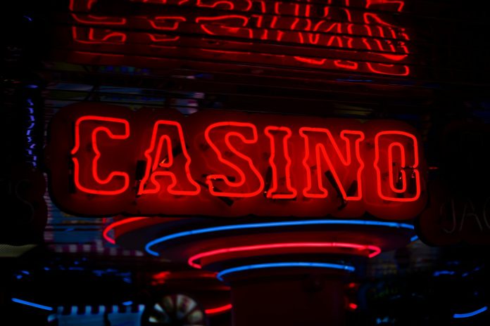 Photo by Ben Lambert red Casino neon sign turned on