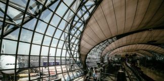 people walking and sitting inside the airport