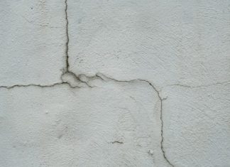 3 Reasons You Should Never Ignore Cracks on Walls and Ceilings in Your Home a crack in the side of a white wall