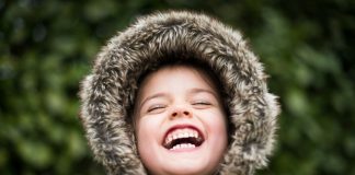 selective focus photography of child laughing