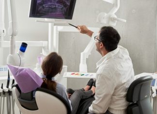 man in white dress shirt holding black pen