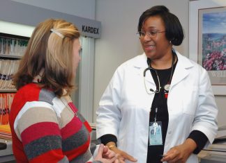 woman in white button up long sleeve shirt holding white card