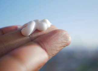 Tips for Choosing the Right Lidocaine Numbing Cream Strength A hand holding a small piece of marshmallow