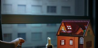 brown wooden house miniature on brown wooden table